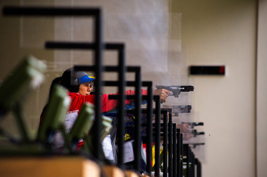mujeres apuntando en competición de tiro deportivo