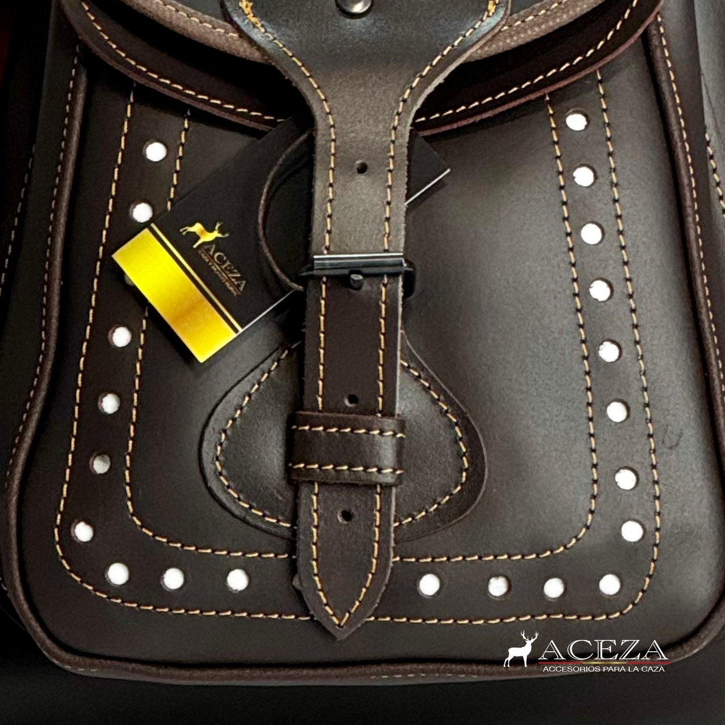 Bolsillo delantero del morral de caza de cuero con calados blancos, ideal para guardar accesorios de caza de forma segura y accesible. Encuentra tu morral perfecto en ACEZA